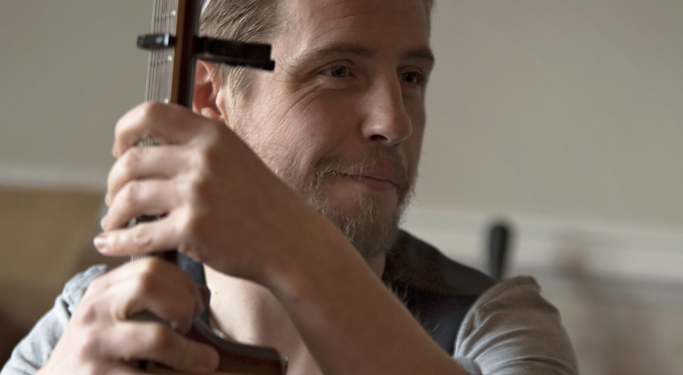 Portrait of Ciaran holding his instrument